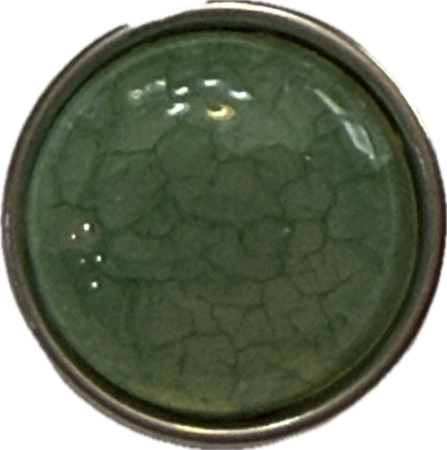 An acrylic jade green snap charm with a 18mm diameter, showcasing a solid green color with a textured, cracked appearance.
