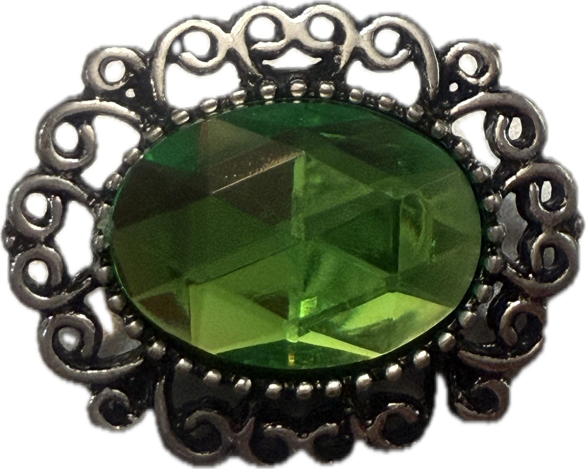 Simple Elegance Jewelry 20mm snap charm with a large oval green rhinestone and intricate silver filigree metal edge.