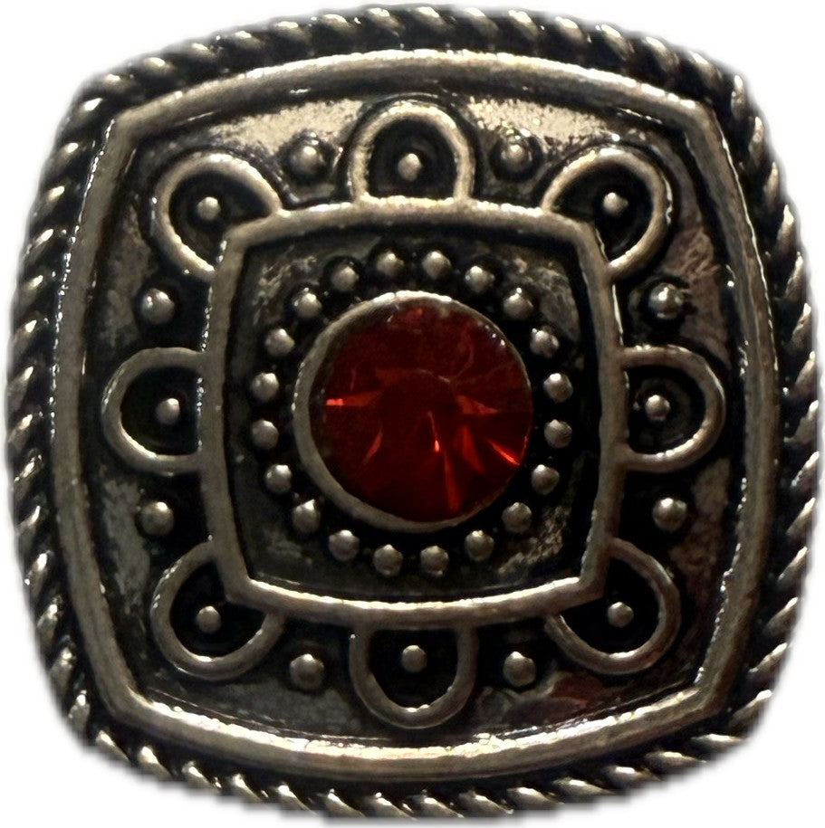 Simple Elegance Jewelry 20mm square snap charm with silver metal filigree and a central red birthstone rhinestone.