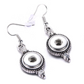 A pair of silver-colored drop snap earrings with rhinestone accents on a white background.