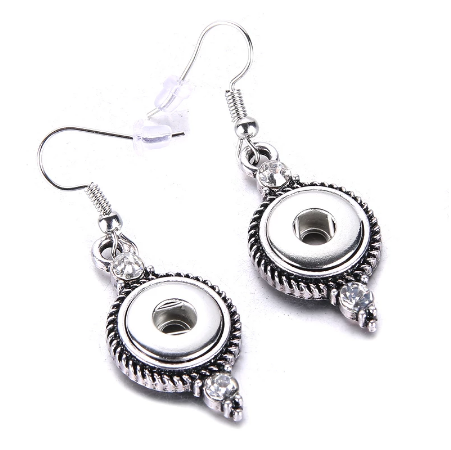 A pair of silver-colored drop snap earrings with rhinestone accents on a white background.